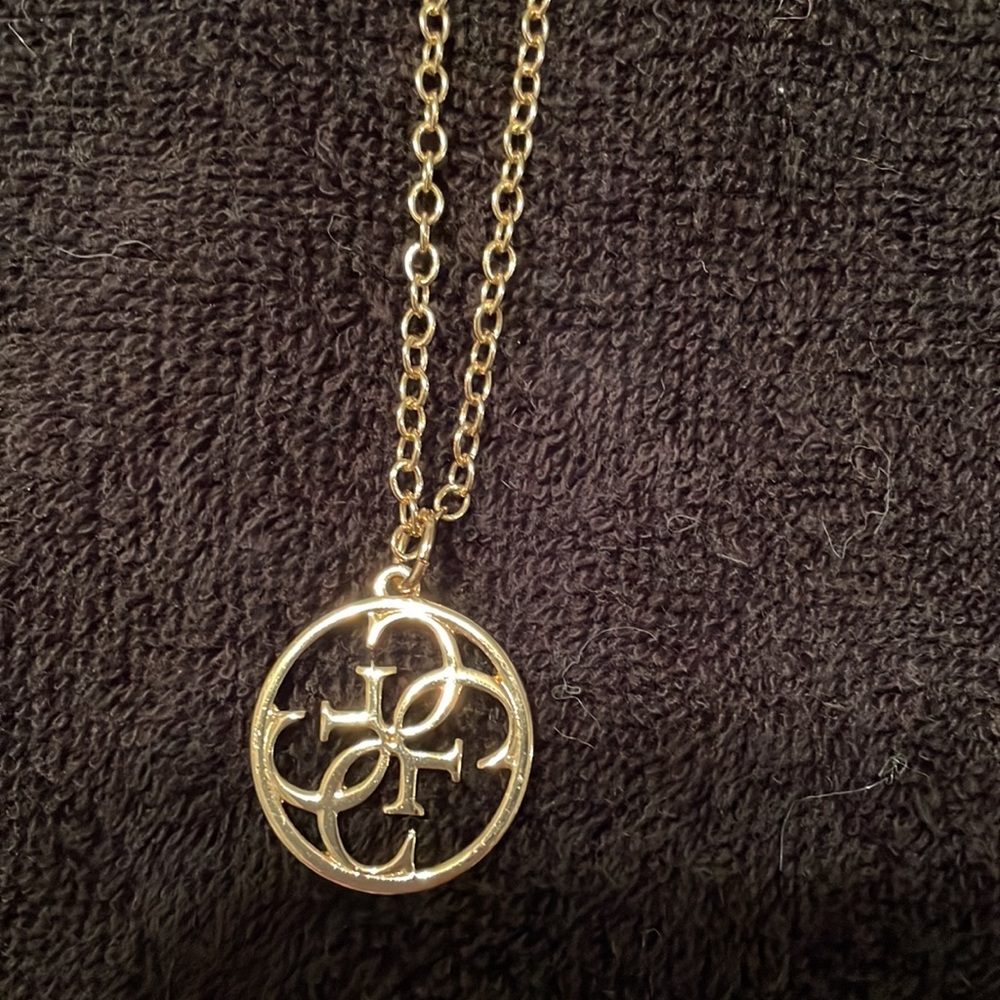 Guess gold tone necklace with a medallion with 4 G’s for Guess.